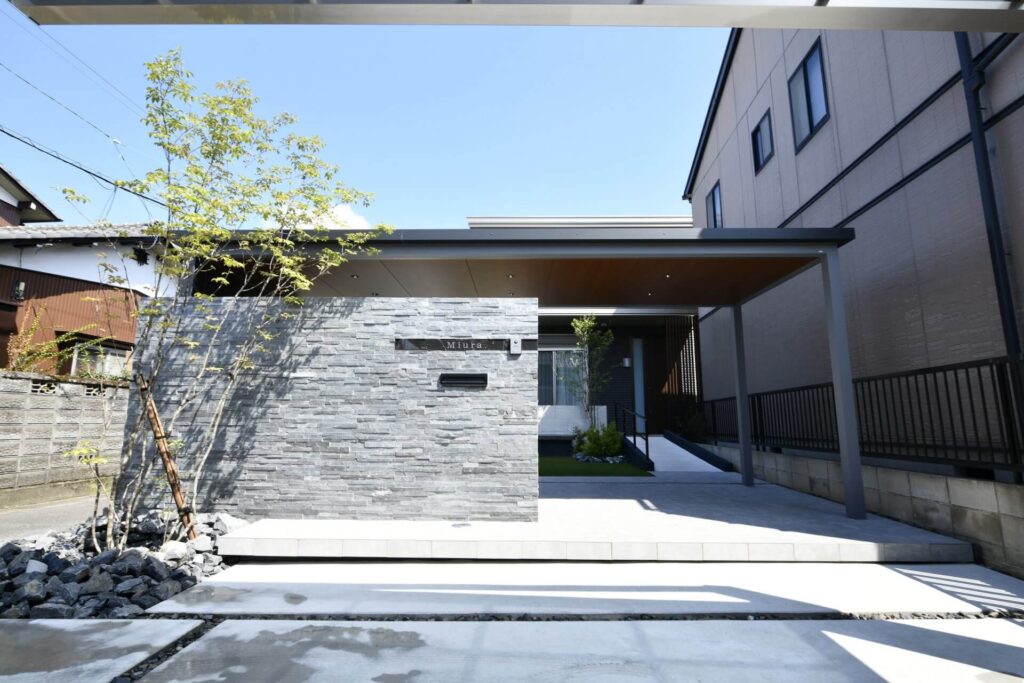 天然石をふんだんに使用した門柱と、重厚感あるエントランスゲートでつくる、高級感あるモダン外構。